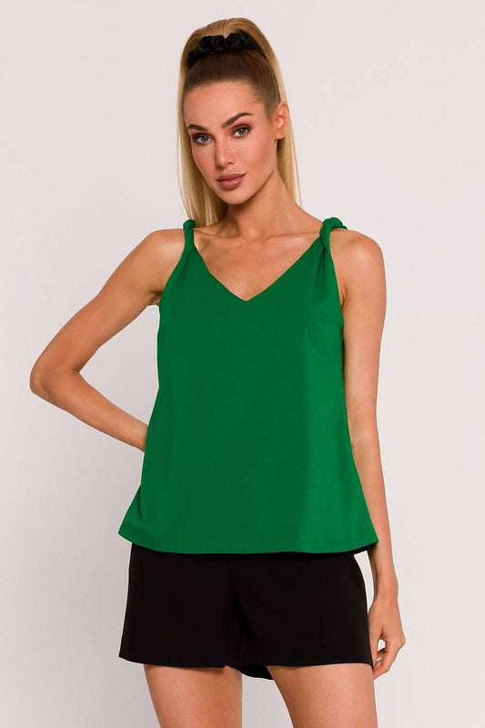 Emerald green sleeveless top with shoulder ties paired with black shorts.