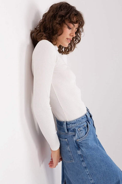 White ribbed long-sleeve bodysuit paired with blue jeans.