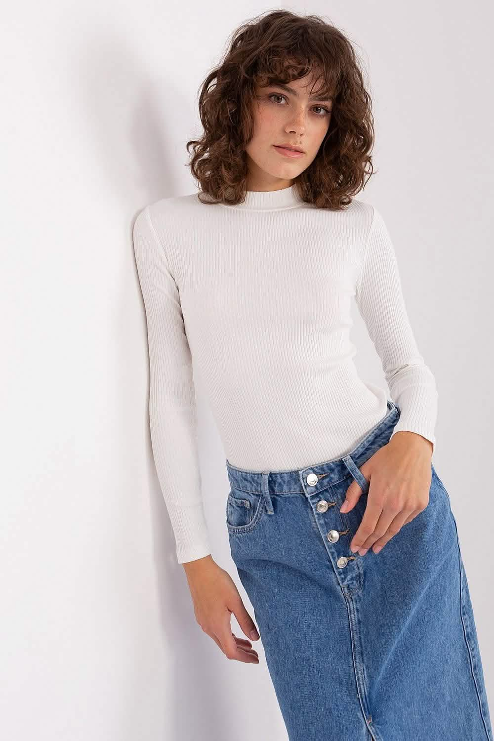 White turtleneck top paired with a button-front denim skirt.