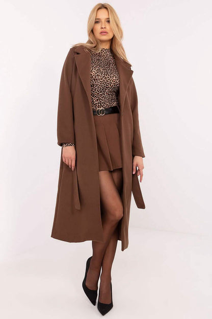 Long brown wool coat with a matching brown shorts and leopard print top ensemble.