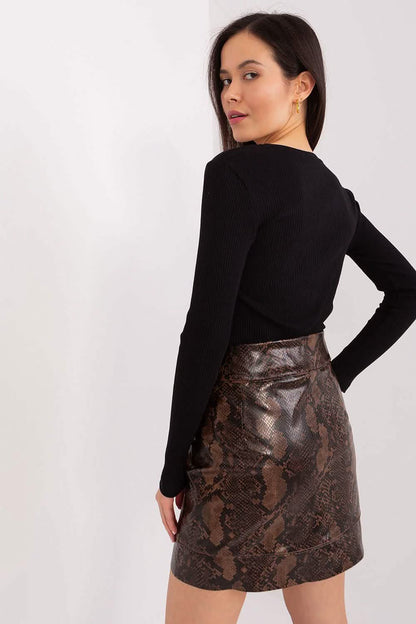 Brown snakeskin print leather mini skirt paired with a black long-sleeve top.