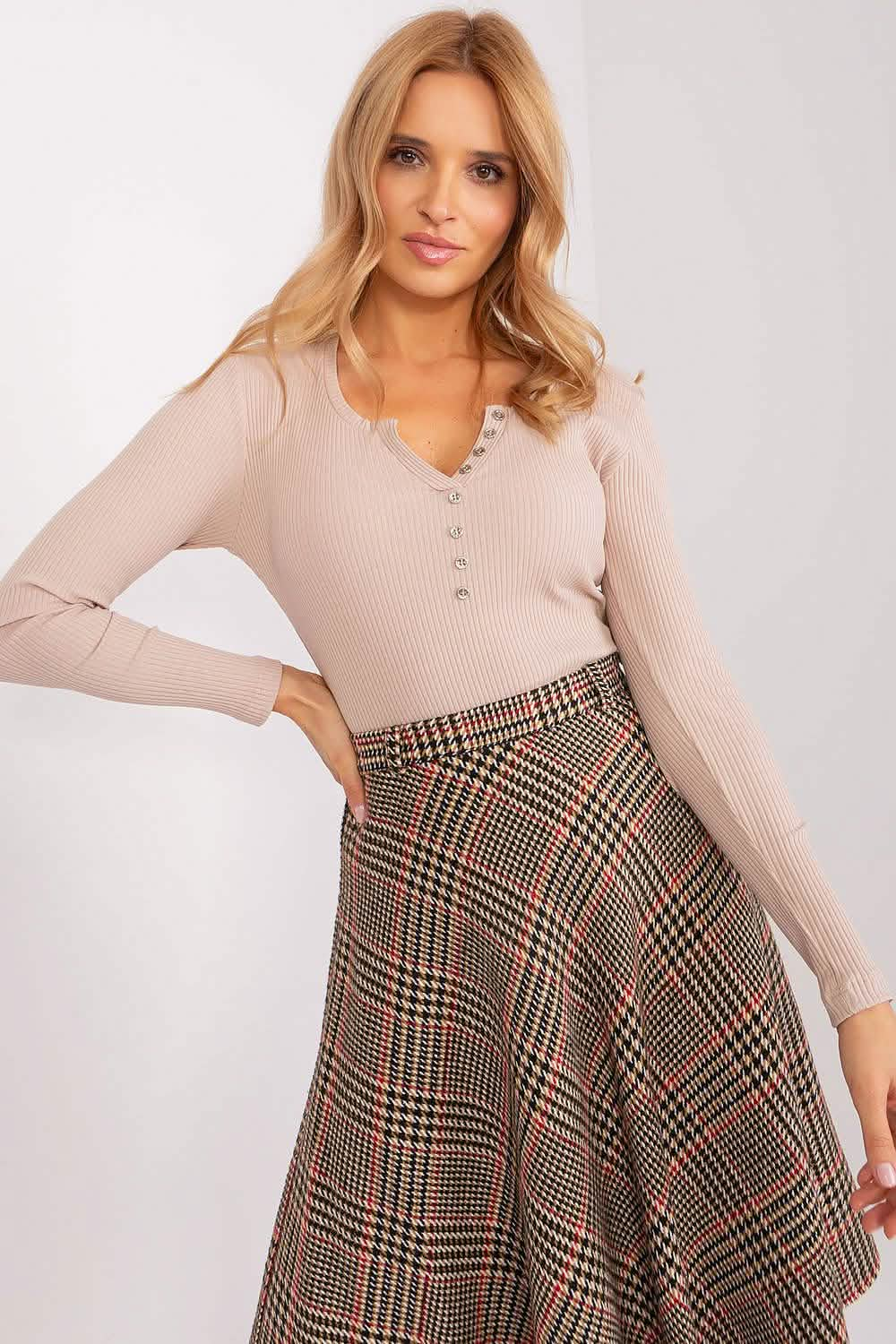 Plaid A-line skirt paired with a pale pink ribbed henley top.