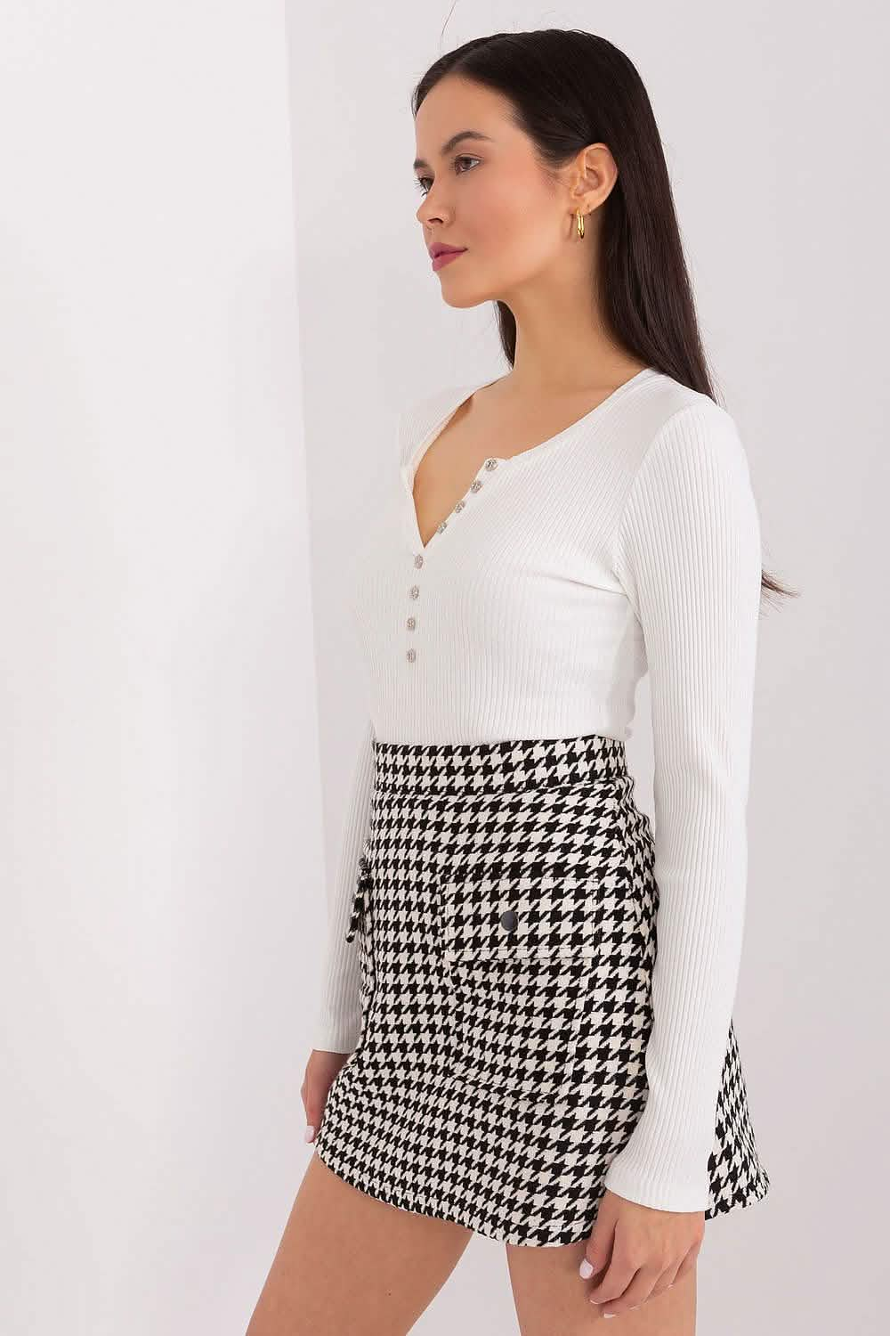 Houndstooth patterned wrap skirt paired with a white henley top.