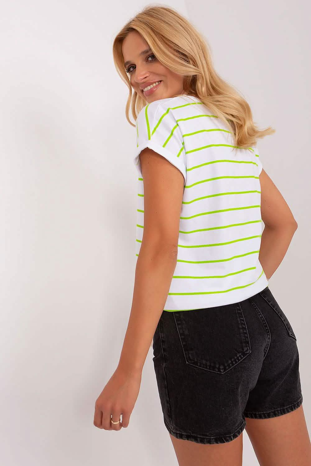 White t-shirt with neon green horizontal stripes paired with black denim shorts.