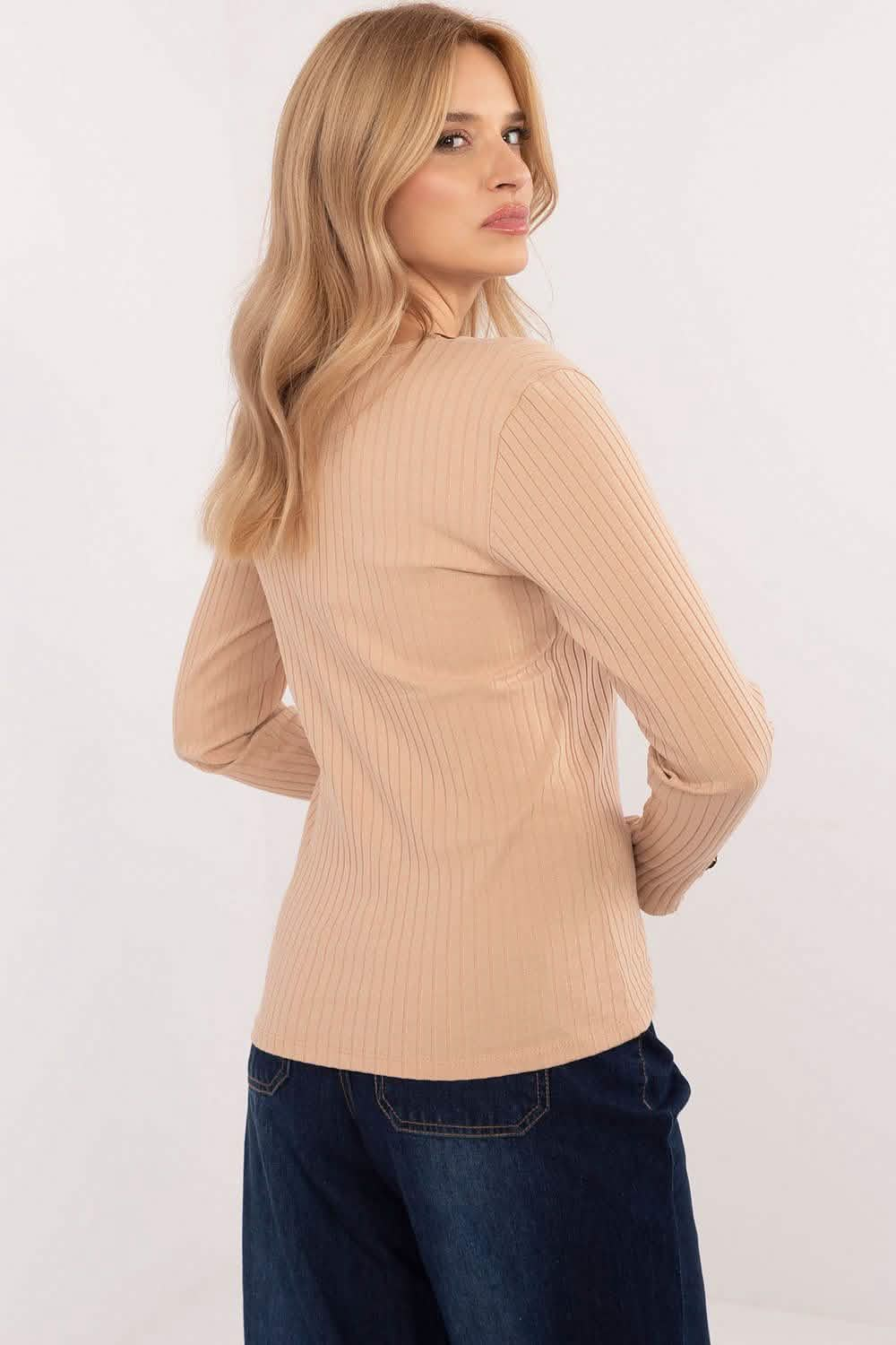 Beige ribbed turtleneck sweater with long sleeves.