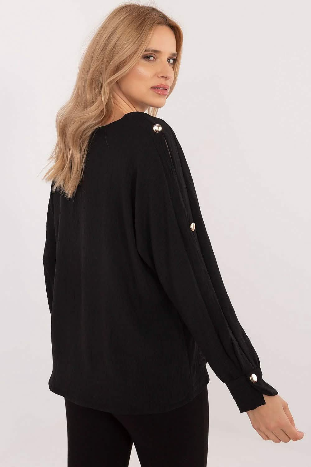 Black knit sweater with decorative button details along the sleeves.