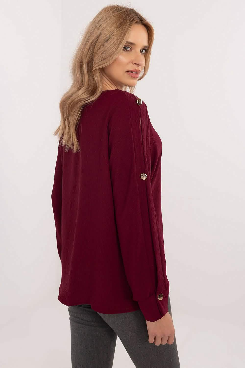 Burgundy knit sweater with decorative buttons on the back.