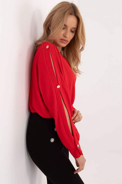 Red long-sleeved blouse with decorative button details along the sleeves.