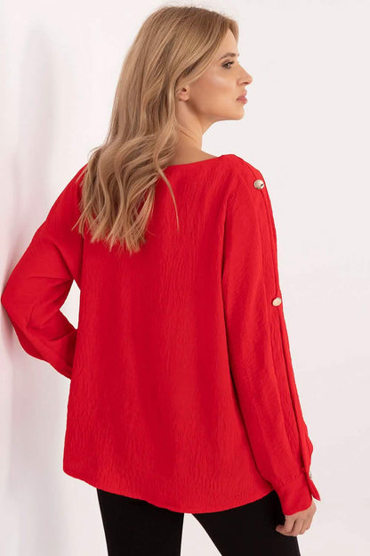 Red long-sleeved blouse with button details on the sleeves.