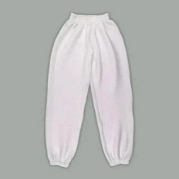 White elastic-cuffed sweatpants with a gathered waistband.