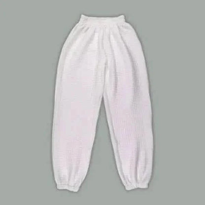 White elastic-cuffed sweatpants with a gathered waistband.