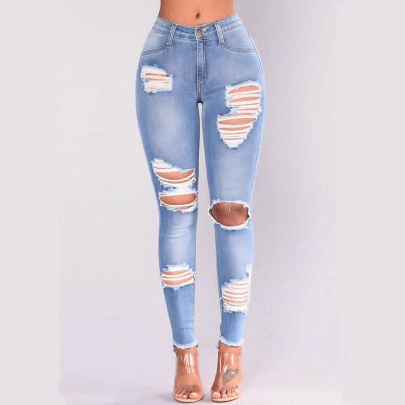 Light blue distressed skinny jeans with multiple rips and tears.