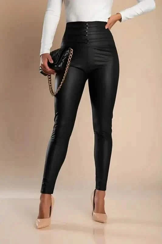 High-waisted black leather-look pants with button details paired with nude heels.