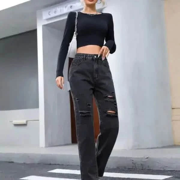 Black ripped mom jeans paired with a cropped long-sleeve top.