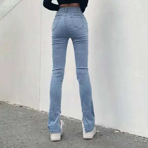 Light blue bootcut jeans with white sneakers.