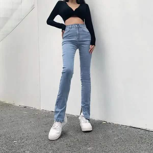 Light blue high-waisted straight-leg jeans paired with white sneakers.