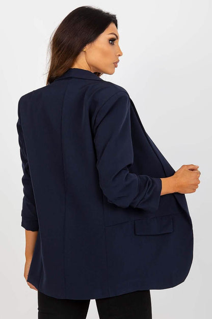 Navy blue blazer with rolled-up sleeves shown from a back view.