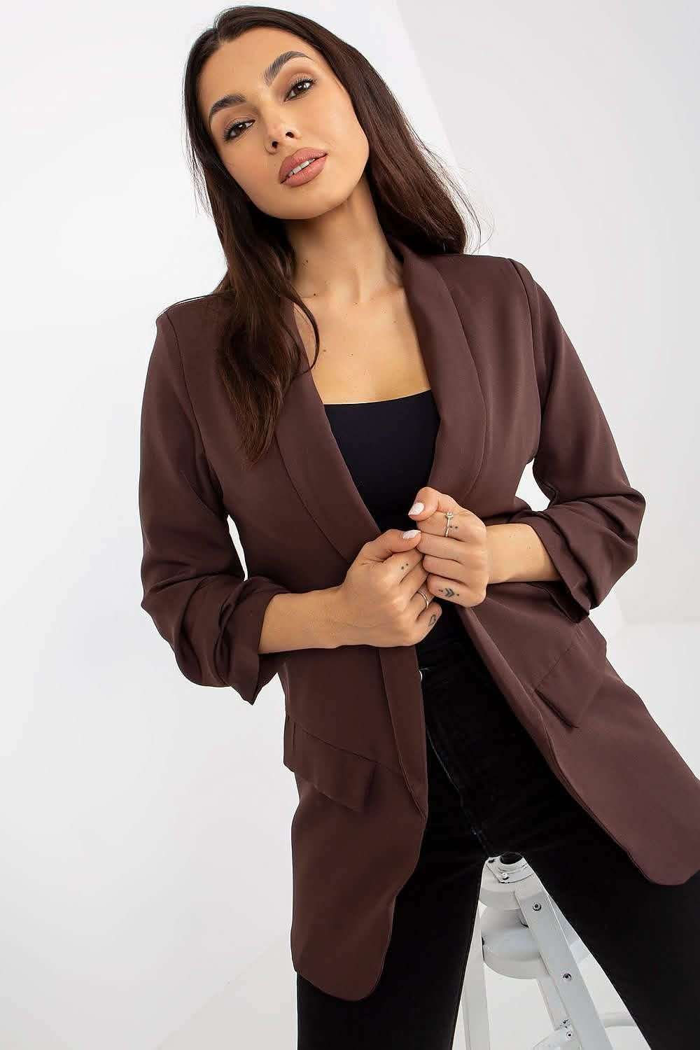 Brown blazer with ruched sleeves over a black top.