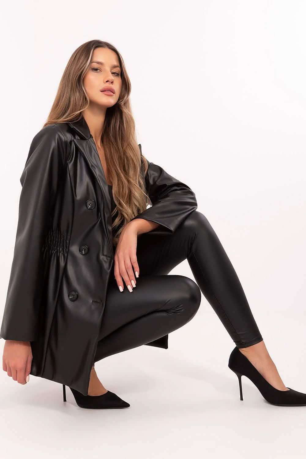 Black leather trench coat styled with matching leggings and heels.