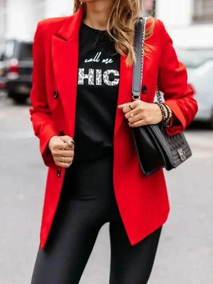 A vibrant red blazer worn over a black graphic t-shirt.