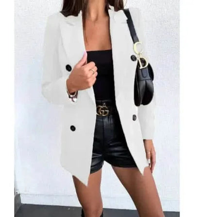 White double-breasted blazer worn over a black outfit.