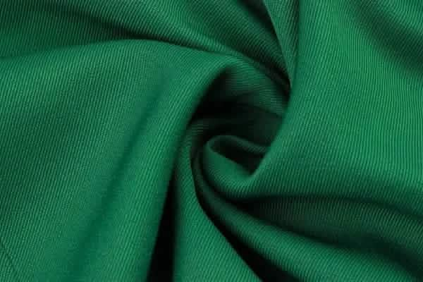 Emerald green fabric with visible diagonal ribbed texture.