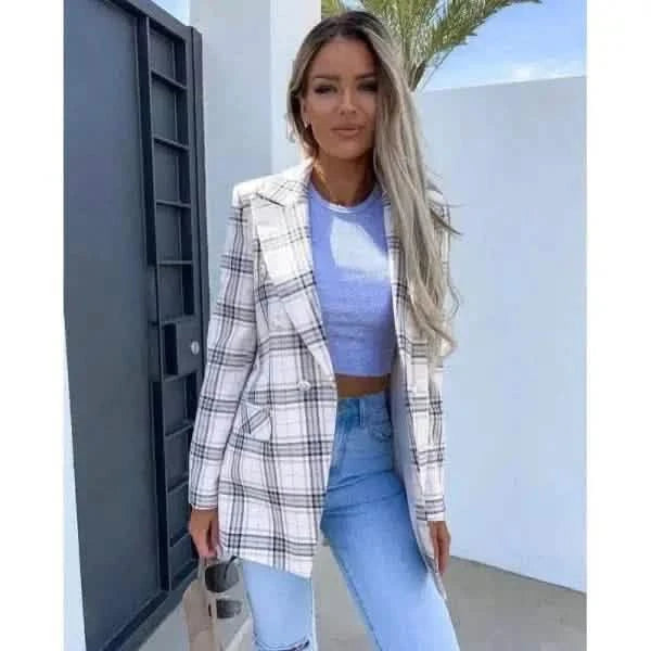 White and black plaid blazer worn with a blue crop top and light-wash jeans.