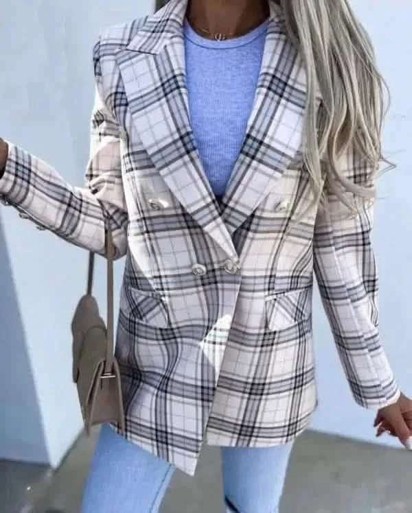 Plaid blazer in white and gray worn over a light blue sweater.