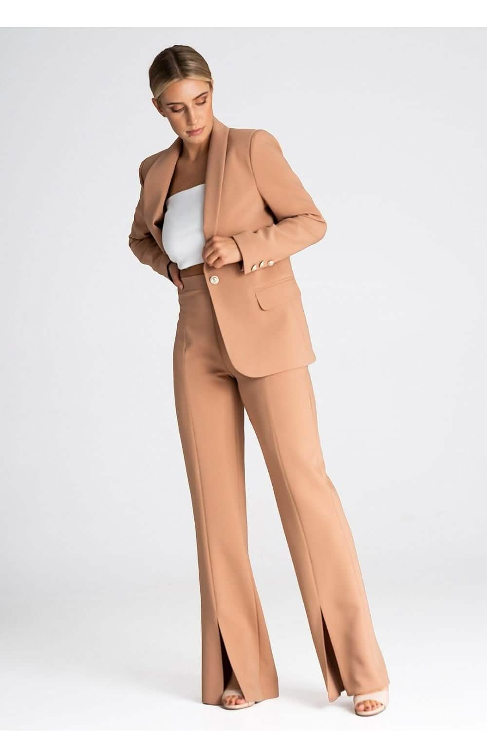 Camel-colored women’s pantsuit with a blazer and split-hem trousers.