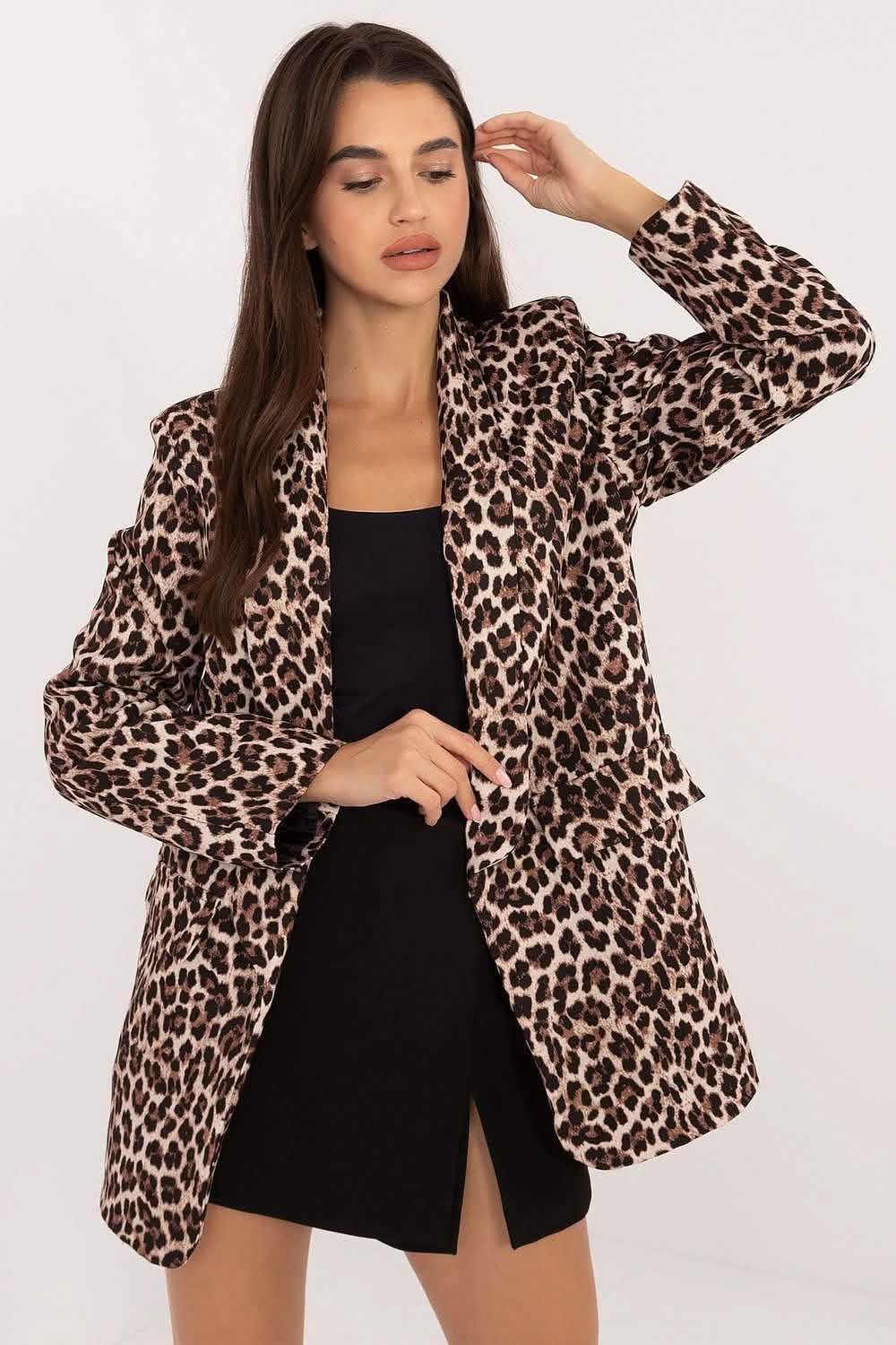 Leopard print blazer worn over a black dress.