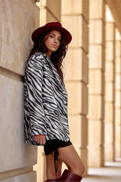 A zebra-print coat paired with a burgundy hat and boots.