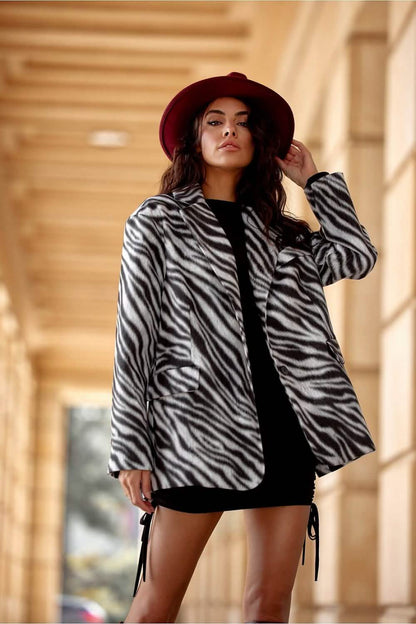 Zebra-print coat worn over a black dress with a burgundy wide-brimmed hat.