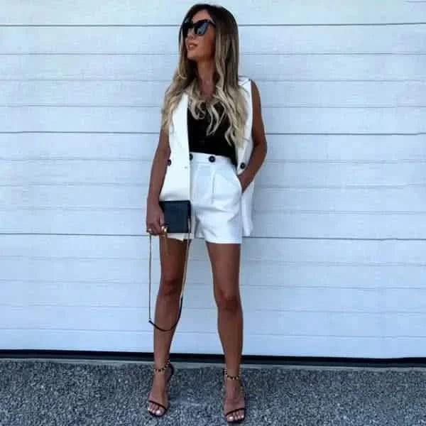 Stylish all-white summer outfit with shorts, sleeveless top, and strappy heels.