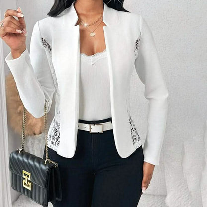 Crisp white blazer with delicate silver embroidered details along the sides.